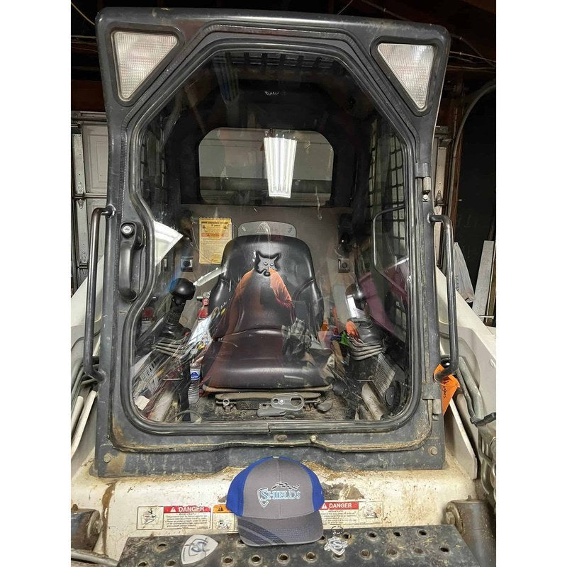 SHIELDS front door window installed on a Bobcat G-Series skid steer, front view