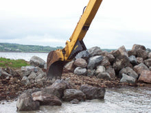 Amulet StickGrip handling rock on an excavator