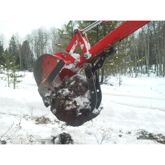 Amulet MT-1 Micro-Thumb rigid mini excavator thumb gripping a root ball in snow