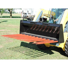 Berlon Industries MTMF manure fork on a loader beside a field