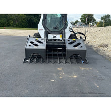 Berlon Industries MDGR2 grapple lowered in front of a skid steer