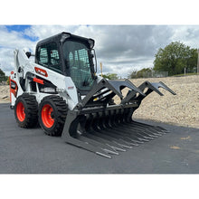 Berlon Industries MDGR2 grapple, side angle on a skid steer