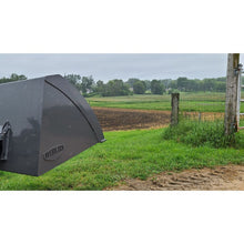 Berlon Industries mini light material bucket raised in a field
