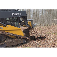 Berlon Industries tree puller pulling a root ball on a John Deere compact track loader