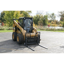 Berlon Industries walk-through pallet forks on a CAT skid steer