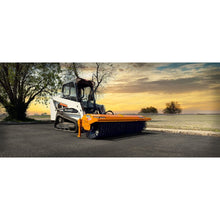Broce BBA96H angle broom attachment on a compact track loader in a parking lot at sunset, front left view