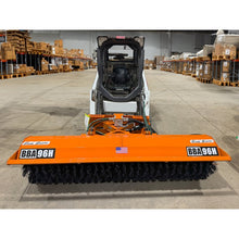 Broce BBA96H hydraulic angle broom on a compact track loader in a warehouse, front view