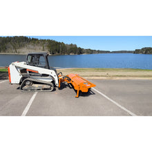 Broce BBA96H skid steer angle broom angled on a compact track loader beside a lake, side view