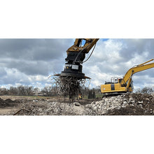 Connect Work Tools excavator magnet lifting scrap rebar from a demolition pile, working view