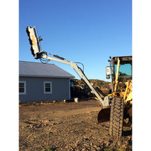 Forax Equipment grader implement boom with the head raised high above a road grader