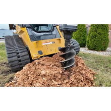 Lowe Manufacturing stump planer boring a stump on a compact track loader