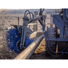 Maxx Attachments bunk sweeper broom and hydraulic motor working along a feed bunk, close up