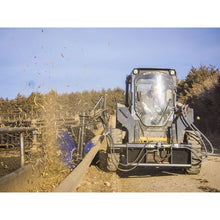 Maxx Attachments bunk sweeper on a skid steer brushing leftover feed out of a feed bunk
