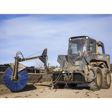 Maxx Attachments bunk sweeper on a John Deere skid steer beside a concrete feed bunk