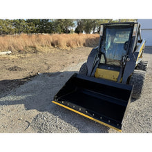 Maxx Attachments general purpose bucket lowered on a skid steer in a gravel yard