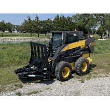 Maxx Attachments Ranch Axe tree shear with brushguard on a New Holland skid steer beside a pond
