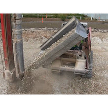 Maxx Attachments side dump bucket dumping gravel to the side at a drilling site