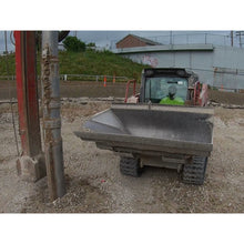 Maxx Attachments side dump bucket held level on a compact track loader, front view