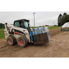 Rock Solid Attachments pallet forks carrying a wrapped pallet on a Bobcat skid steer
