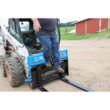 Rock Solid Attachments walk-through pallet forks on a Bobcat skid steer, operator on the step
