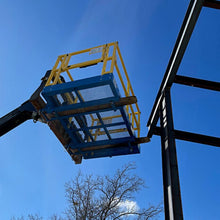 Star Industries safety work platform lifting a crew at a steel building