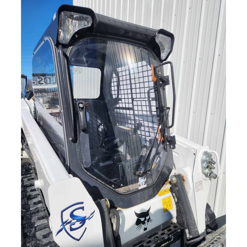 SHIELDS front door window installed on a Bobcat M-Series machine, three-quarter view