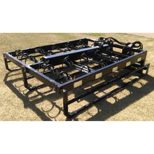 Top Dog Attachments 10 bale accumulator grapple on the grass, view of the hooks and cylinder