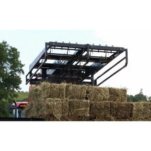 Top Dog Attachments bale accumulator lifting a stack of square bales on a tractor loader