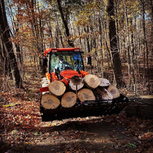 Top Dog Attachments firewood bucket loaded with firewood on an orange compact tractor