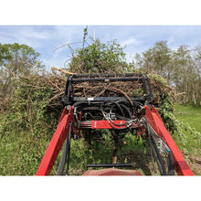 Top Dog Attachments Granite grapple carrying a load of brush on a tractor loader