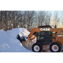 Top Dog Attachments snow bucket on a Case skid steer beside a snow bank