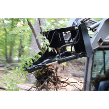 Top Dog Attachments tree puller on a loader pulling brush out by the roots