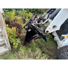Top Dog Attachments tree spade on a skid steer digging out a shrub